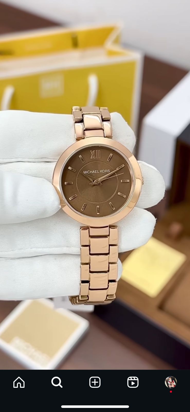 Bvlgari watch with a stainless steel and rose gold case, diamond bezel, and a red dial.