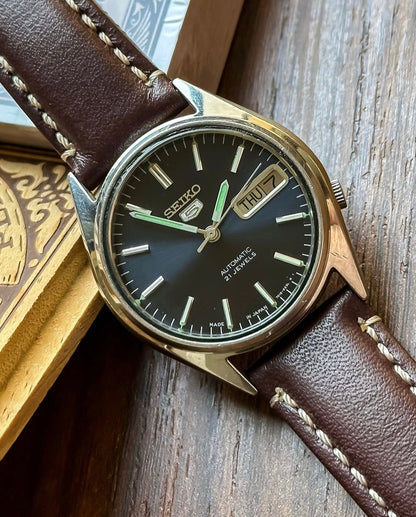 Vintage Seiko 5 Automatic watch with a navy blue dial and a brown leather strap