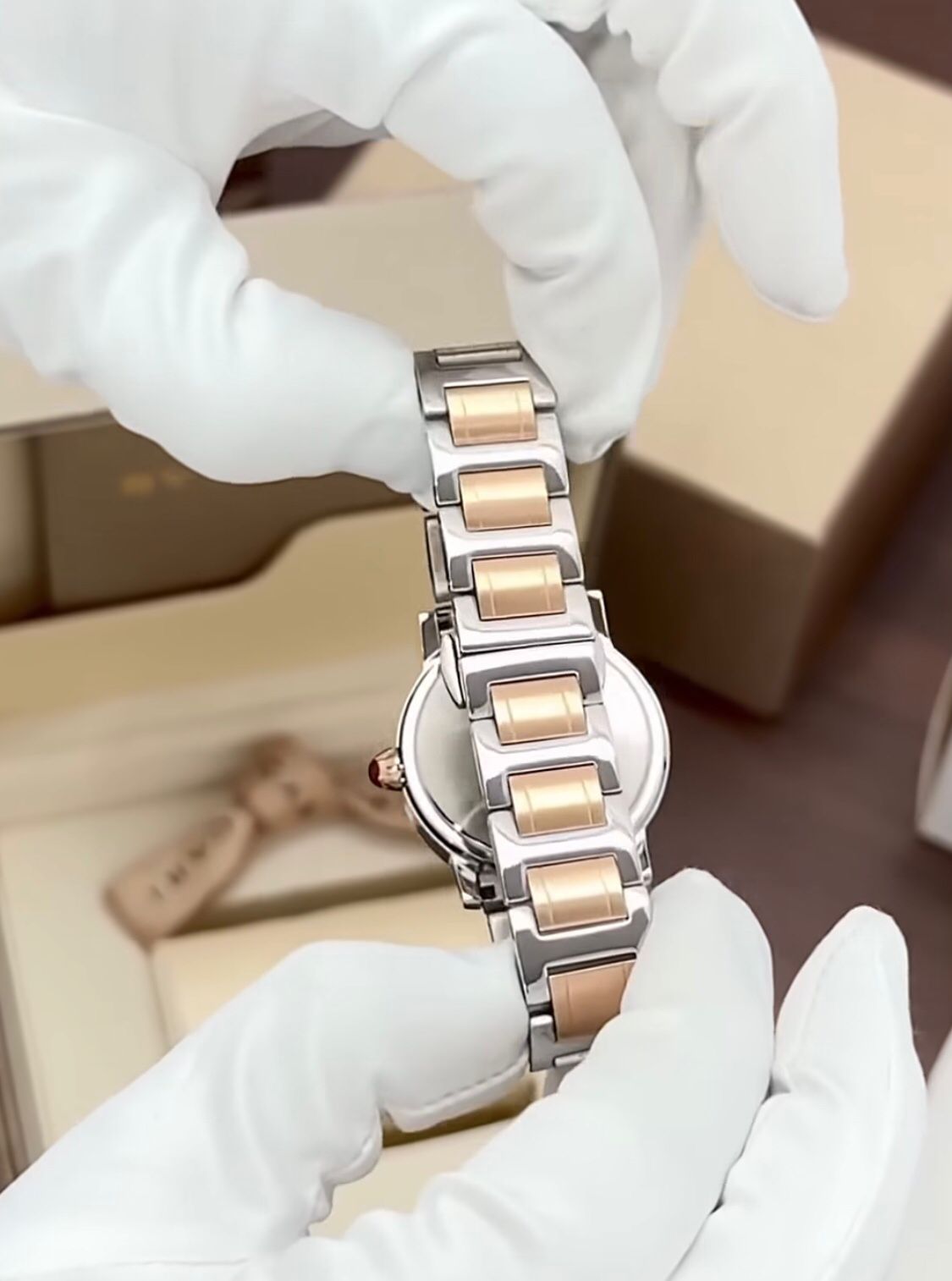 Bvlgari  watch with a stainless steel and rose gold case, diamond bezel, and a red dial.