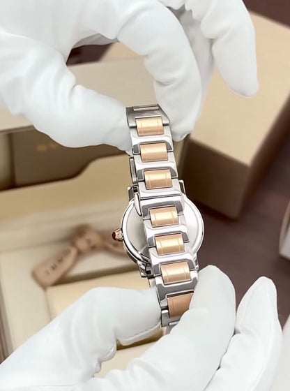 Bvlgari  watch with a stainless steel and rose gold case, diamond bezel, and a red dial.