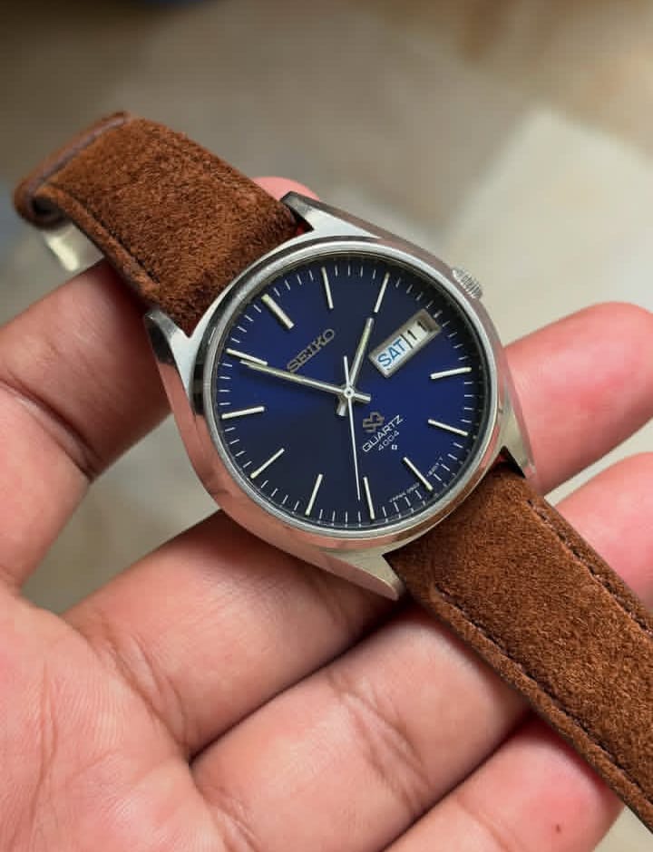 Vintage Seiko SQ 4004 watch with a blue dial and a brown leather strap