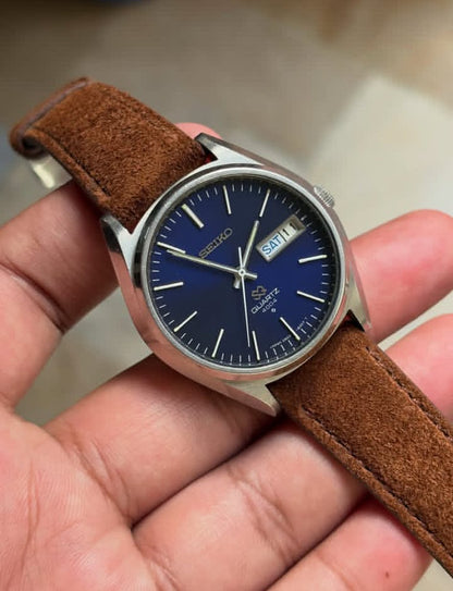 Vintage Seiko SQ 4004 watch with a blue dial and a brown leather strap