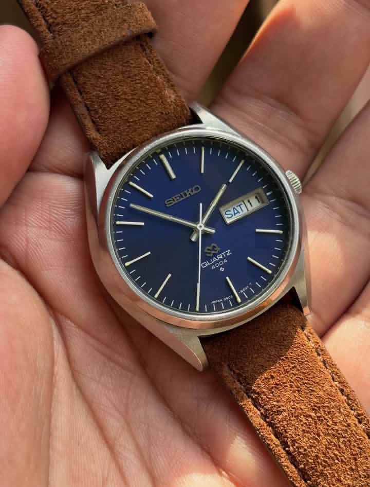 Vintage Seiko SQ 4004 watch with a blue dial and a brown leather strap