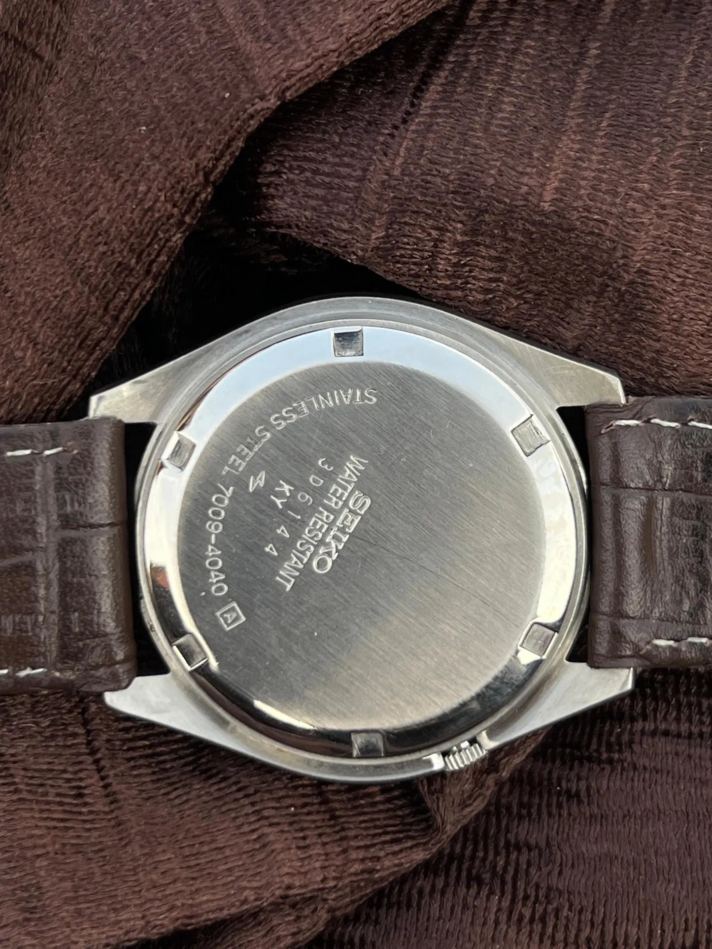 Vintage Seiko 5 Automatic watch with a navy blue dial and a brown leather strap